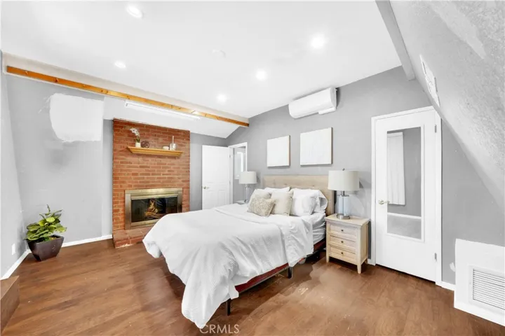 A second set of stairs by the garage leads to a bedroom with patio access, a romantic fireplace
