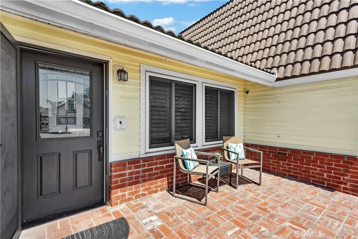 complete with a solid wood door featuring leaded glass inlays and custom security screens valued at over $30,000