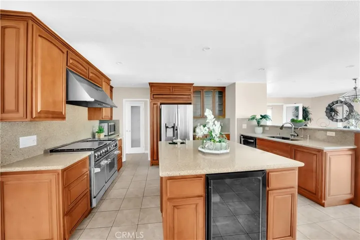 The large center island features an additional sink, ample storage, and a wine refrigerator.