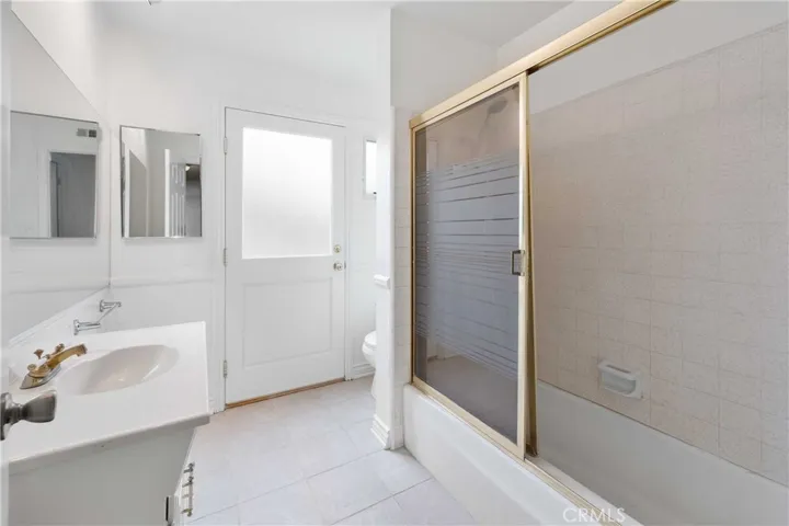 Main hallway bath is a full bath  with door to backyard