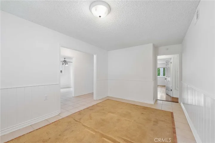 Dining Room in-laid rug can easily be replaced by room-sized carpet or tile flooring