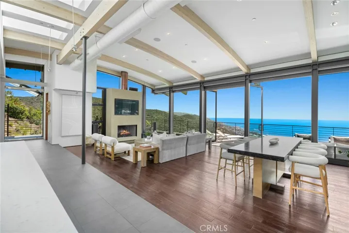  Anchored by a gas fireplace, the great room opens to a wraparound ocean-view deck.