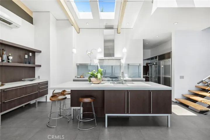 Chefs will appreciate the convenience and style of a dumbwaiter, large island, glass backsplash, and a fully appointed butler’s pantry.
