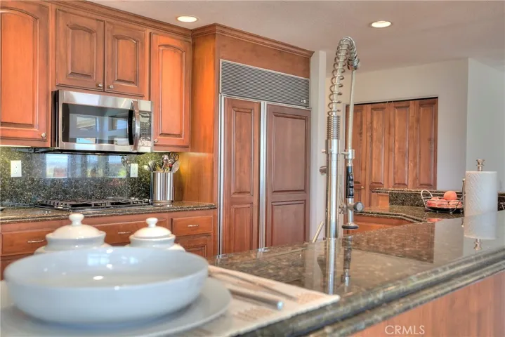 The kitchen features upgraded counters and custom refrigerator doors for a modern touch.