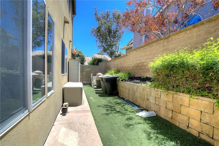 Side view of home with artificial grass for easy maintenance