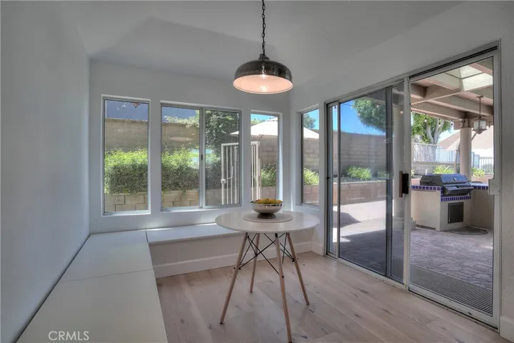 The breakfast area off the kitchen features a built-in seats with views of the BBQ and Pool area