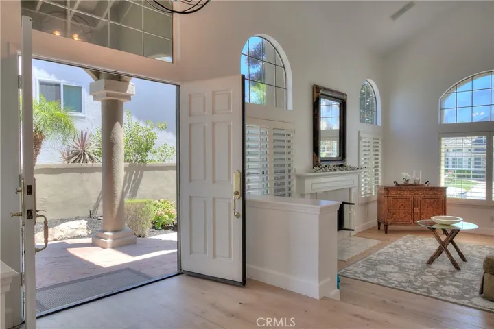 Step inside to discover an inviting open floor plan flooded with natural sunlight, accentuated by high vaulted ceilings that create an airy and spacious ambiance.