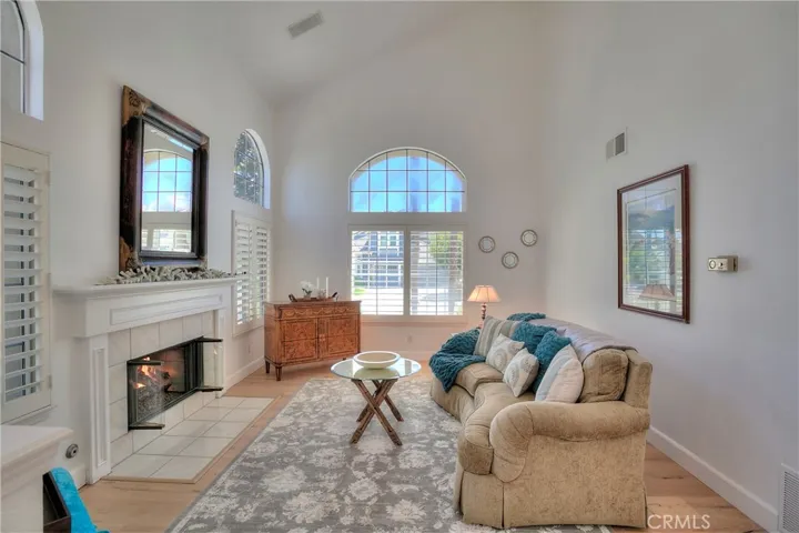 Upon entry, you are greeted by a spacious living area enhanced with vaulted ceilings, and a welcoming fireplace.