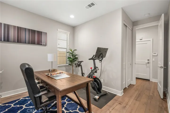 View of the downstaris office / bedroom facing the exit. The bathroom is to the left of the exit.