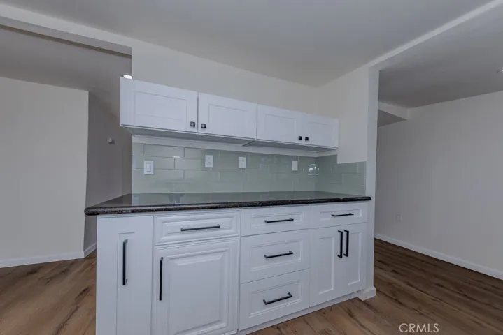 Lovely Granite Counters with Glass Tile Backsplash