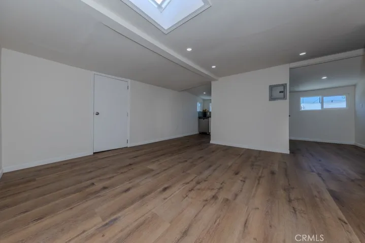 Living Room with Skylight Back House