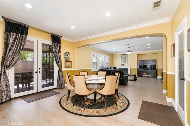 Double glass French door with security screen door open to the back yard from family kitchen. Custom beautiful drapes