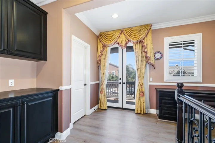 French glass doors with custom drapes open to the balcony