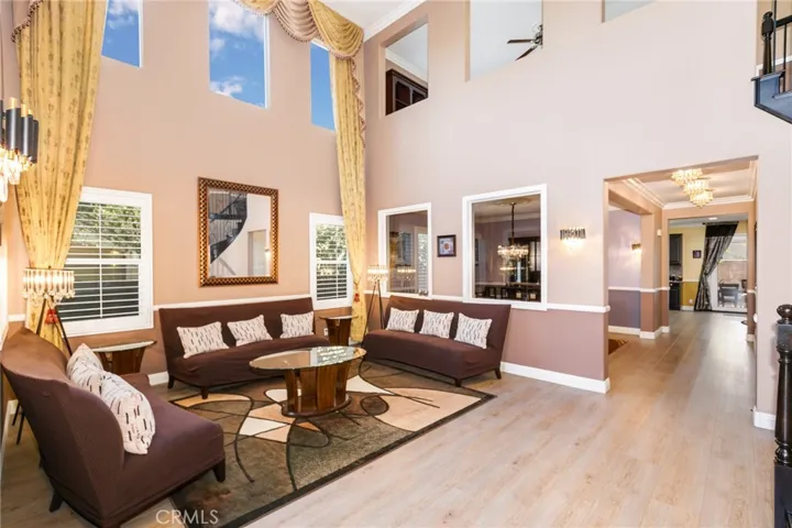 Custom drapes with High ceiling spacious natural sunlight. 5-inch base board and withe wood chair railing