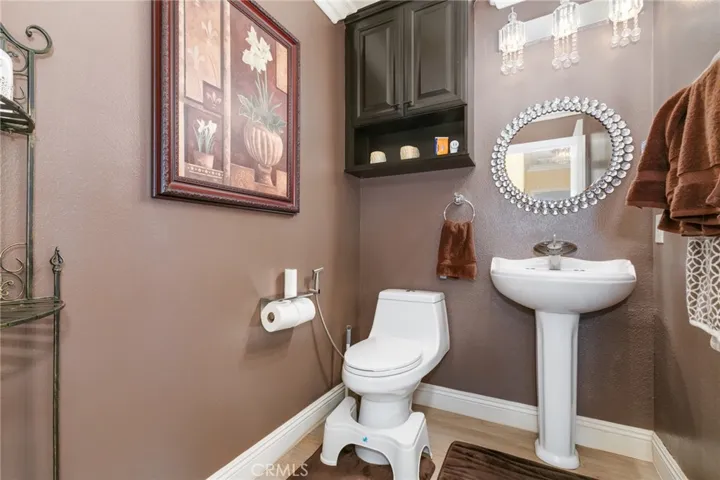 Hallway powder with remodeled light fixture and toilet