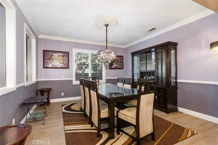 Formal dining room with gorgeous chandelier with fan and crown molding