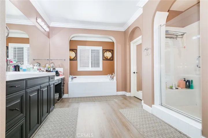 Main bathroom with Jacuzzi tub, Walk-in glass door shower, vanity fixtures, double sink, dressing area