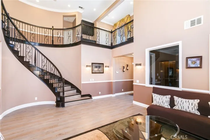 Curving staircase goes to upstairs along with hallway