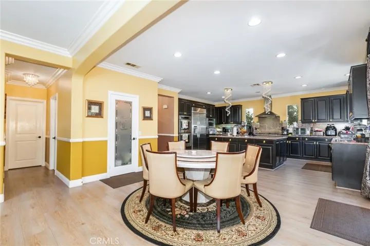 Hallway with chandelier from family room to powder room and laundry room. Crown molding in the whole house.