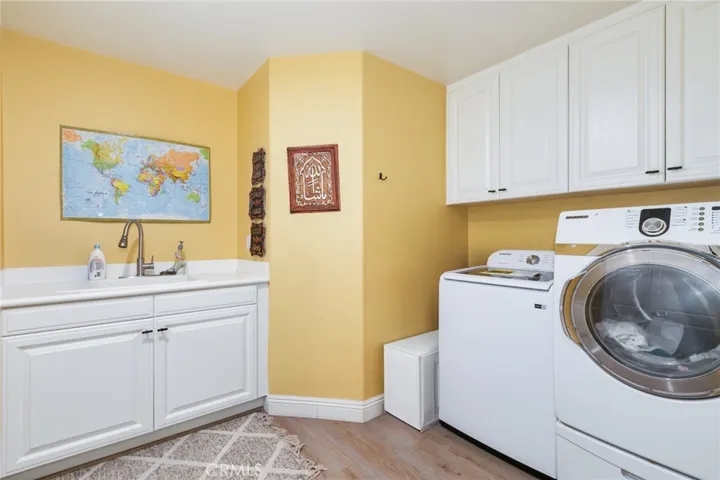 Laundry room with sink and cabinets