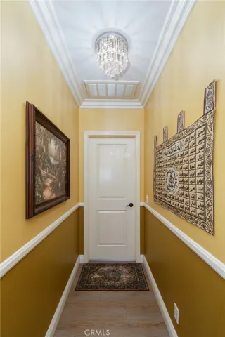 Downstairs bedroom has his own hallway with chandelier