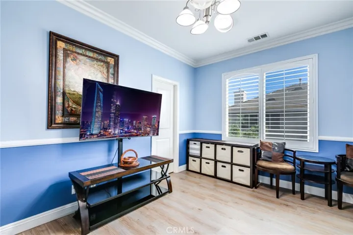 3rd bedroom with chandelier and clown molding, plantation shutter, designer paint and walk in closet