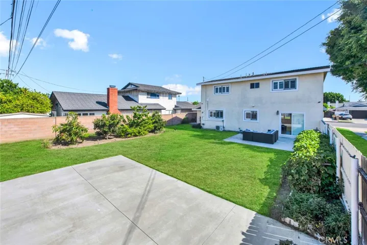 Park-Like Backyard with concrete Patio and Endless Lawn, Block Wall Fencing, Plus Many Fruit Trees