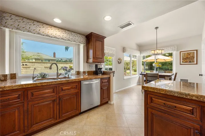 The open layout for the kitchen, breakfast room and family room accommodates large groups for entertaining. Numerous windows provide an open feeling. Granite counters and stainless steel make for easy clean up.