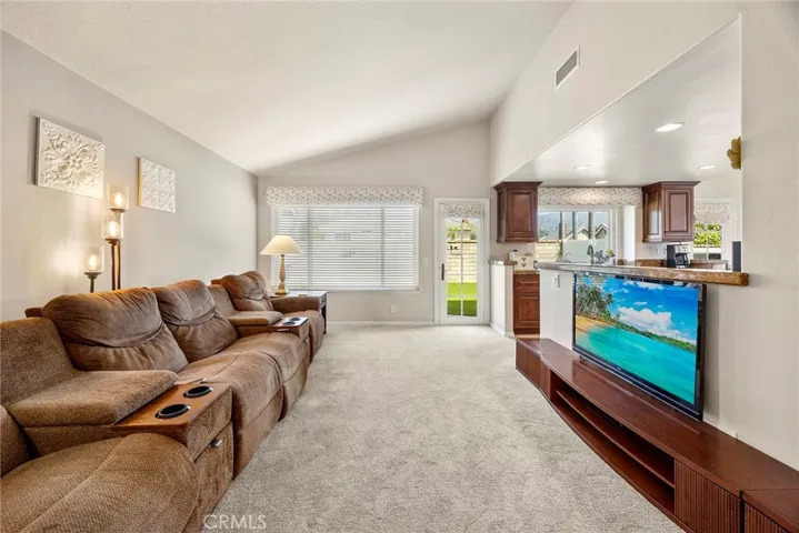 This is the casual family room. Note the convenient access to the kitchen on the right. French door leads to the private yard.