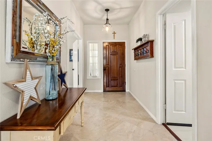 Greet guests in the entry foyer with travertine floors.