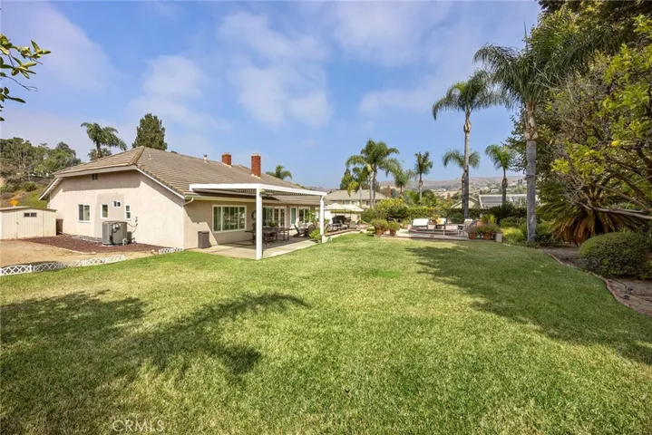 This backyard includes fruit trees, such as grapefruit and lemon. Also, note the shed on the left side of photo. It will stay with the property. It stores outdoor tools, such as mower, power washer, etc.