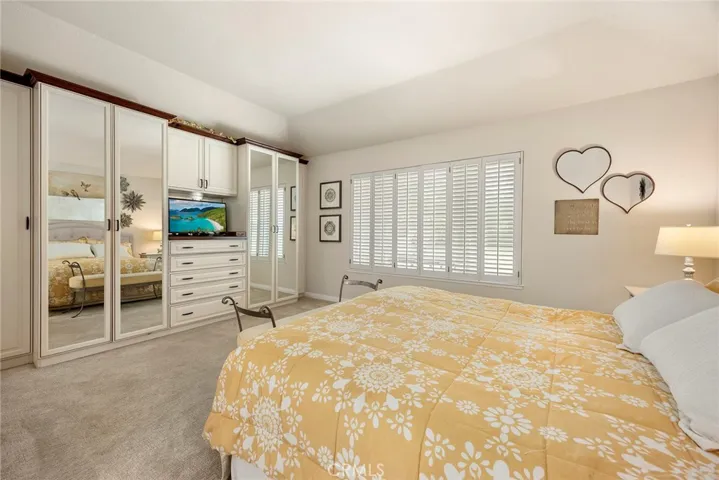 Beautiful built-in provide plenty of closet and drawer space. There are additional closets in this primary bedroom. Windows open to backyard views.