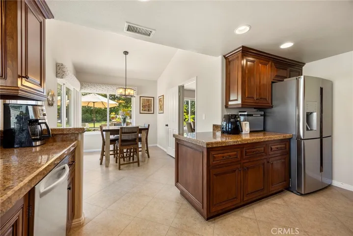 This view of the kitchen shows multiple counter spaces for multiple chefs preparing meals.