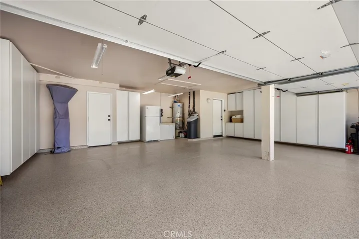 This is the most meticulous garage EVER! With epoxy flooring and built-in closed storage, it will be easy to be organized. Note the purchased water softener; it is not leased.