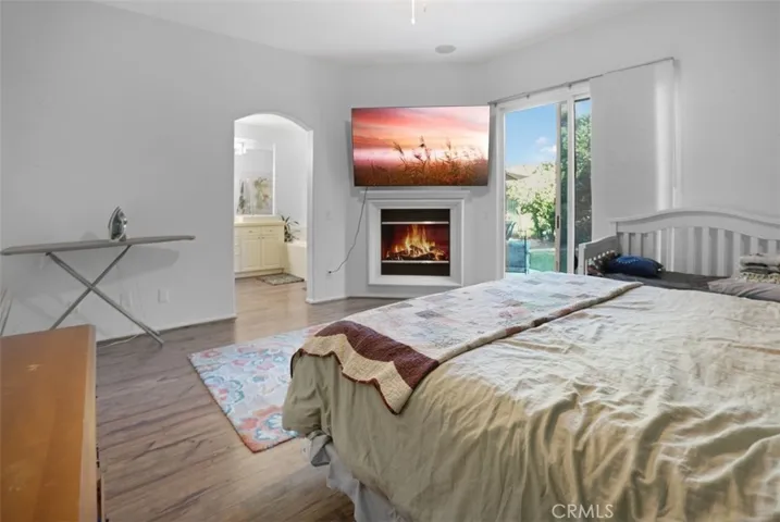 Master Bedroom with fireplace and looking into Master Bathroom