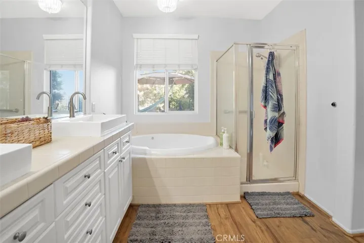 Master Bathroom with double sinks, soaker tub, and separate shower