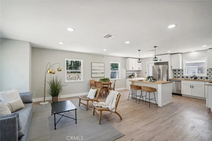 Open Airy living room adjoins dining and kitchen area