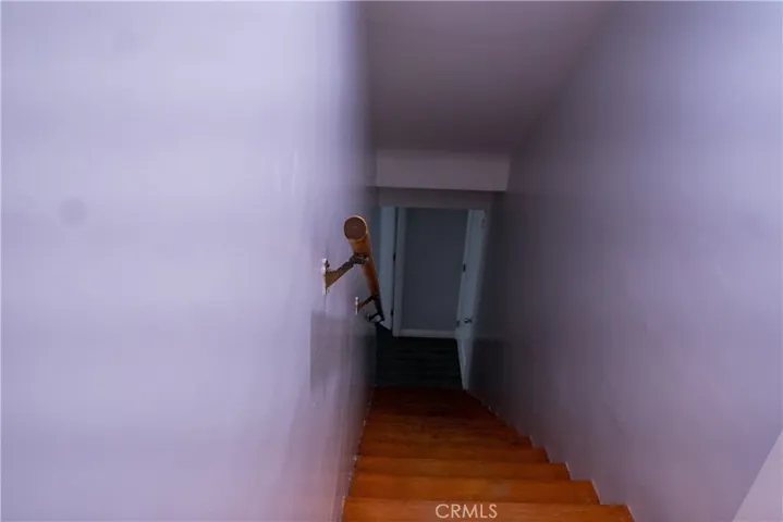 Stairway to downstairs bedroom, garage attic and pantry.