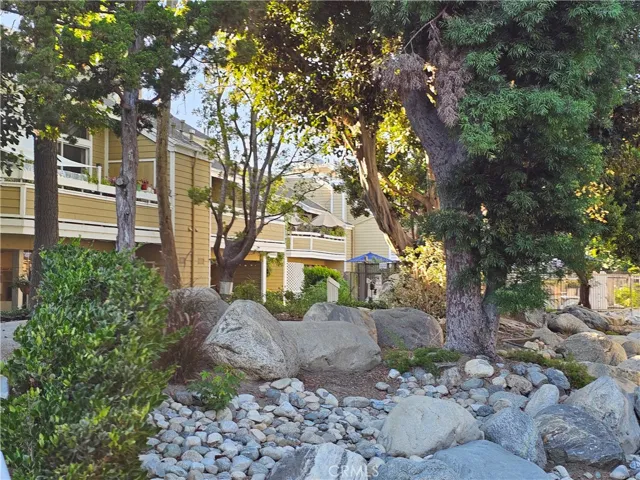 View of community interior; nicely landscaped with winding paths, trees, streams and rock waterfalls.