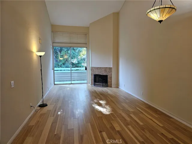 Dining Room and Family Room with fireplace, leads to large balcony.