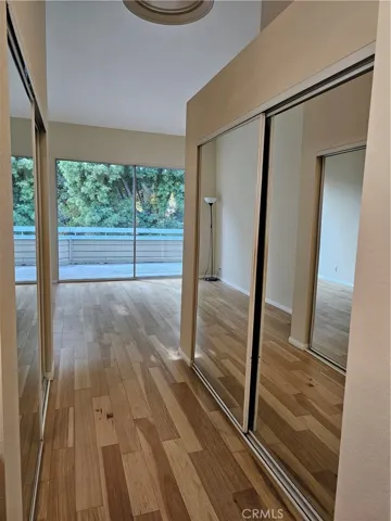View from primary en suite bathroom with double, mirrored sliding closet doors.