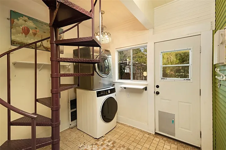 Laundry area with spiral staircase to loft
