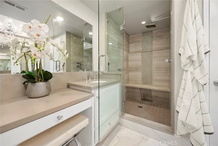 Shower with Glass Tile Waterfall Style Feature.