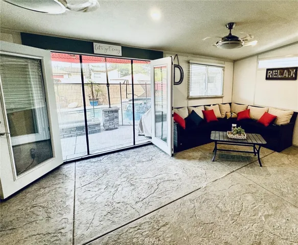 Covered and enclosed patio leading from the main house to the pool and spa