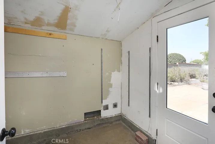 Additional space for storage, gardening equipment, etc. Door leads to backyard.