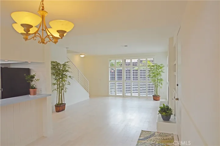 At the far end of the living room, more sliding glass doors open to the large private patio.