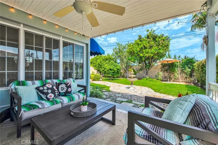 Large Private Backyard is Truly a Tranquil Sanctuary from the Outside World with its Lush Foliage, Fountain, Covered Patio, Awning, Flagstones, Lawn, Brick-Accented Decking, Vegetable Garden Area, Custom-Built Shed that Matches the House, 2 Additional Secluded Patio Areas, and Multiple Fruit Trees - Avocado, Pomegranate, 2 Orange, Lemon, Limon, Grapefruit, and Apple.