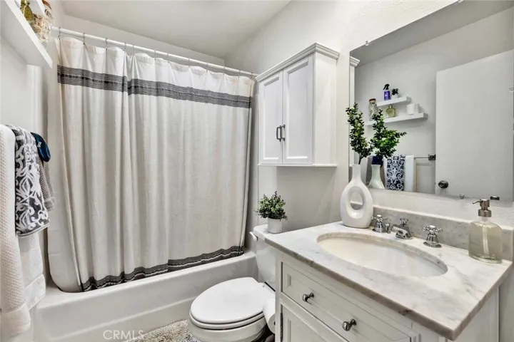 Primary Suite Bathroom has a Tub/Shower with New Surround, Skylight, New Vanity, and New Fixtures