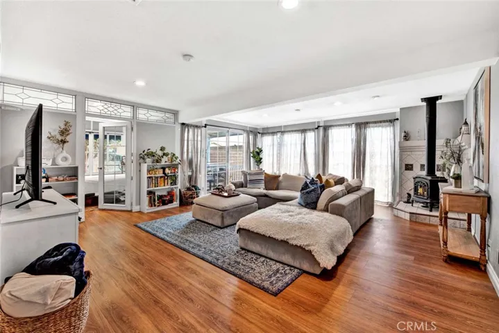 Amazing 528 SqFt Enclosed Patio that is Designed as a Huge Family Room, Plus Separate Office, with Pot-Belly Fireplace, Recessed Lighting, and Vented for Heat and A/C.