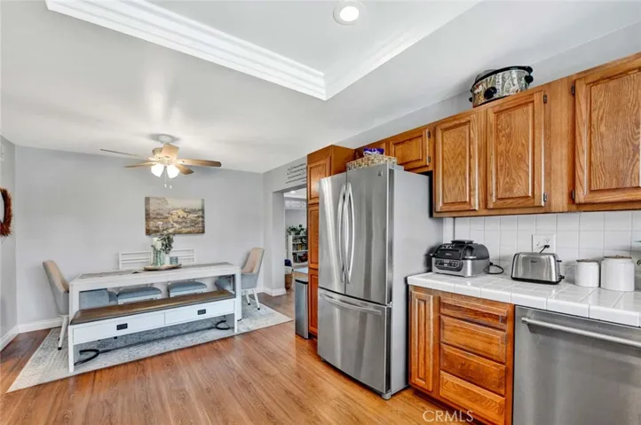 The Kitchen is Open to a Spacious Dining Room with a Ceiling Fan.
